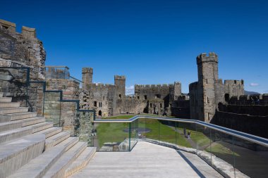 Gwynedd,Great Britain - September 1, 2023: Part of Caernarfon Castle. It is a medieval fortress in Gwynedd clipart