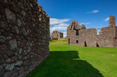 Stonehaven, İskoçya - 4 Ağustos 2022: Dunnottar Kalesi 'nde turistler. Stonehaven 'ın yaklaşık 2 mil güneyinde, İskoçya' nın kuzeydoğu kıyısındaki kayalık bir burnun üzerinde yıkılmış bir ortaçağ kalesi..