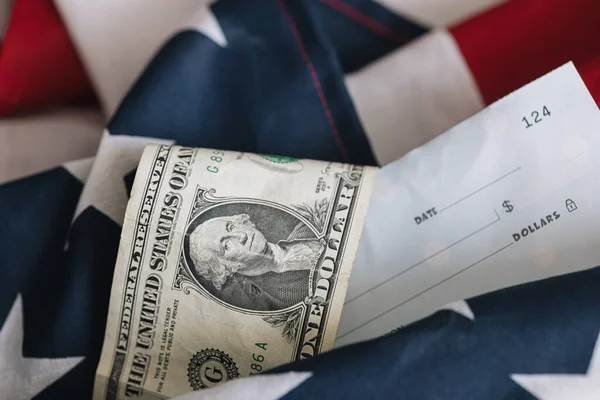 stock image business and economic concept, Untied States dollar bill on an american flag with a blank check.