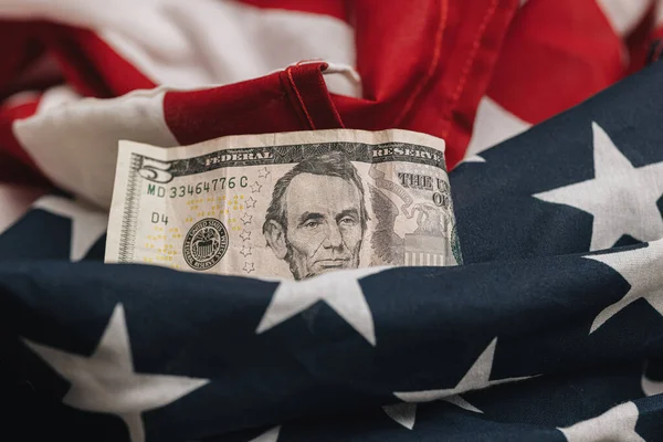 stock image business and economic concept, Untied States five dollar bill on an american flag with a blank check.