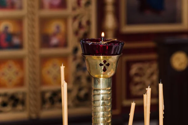 Wax candles in the interior of the church. Orthodox christian candles. Christianity. Ambiance of church, candles and bokeh yellow lights. Religion faith pray symbol.