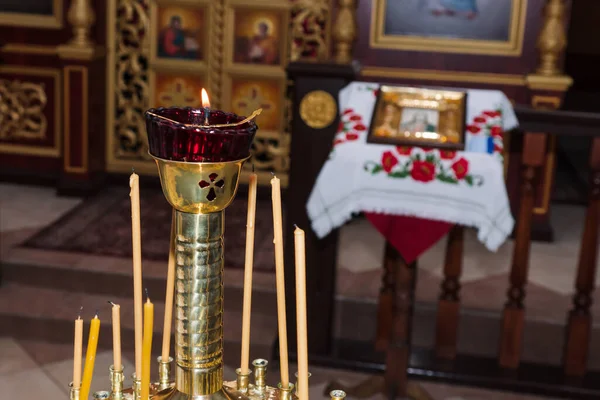 Wax candles in the interior of the church. Orthodox christian candles. Christianity. Ambiance of church, candles and bokeh yellow lights. Religion faith pray symbol.