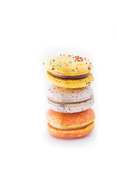 Tasty colourful macaroons. Three multi-colored orange, pink and yellow macaroons. French pastry made from egg whites.