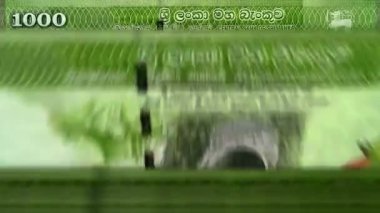 Sri Lanka parası Sri Lanka Rupi para sayma makinesi ve banknotlar. Hızlı bir LKR para biriminin rotasyonu. İş ve ekonomi. Kavramsal ve pürüzsüz arkaplan.
