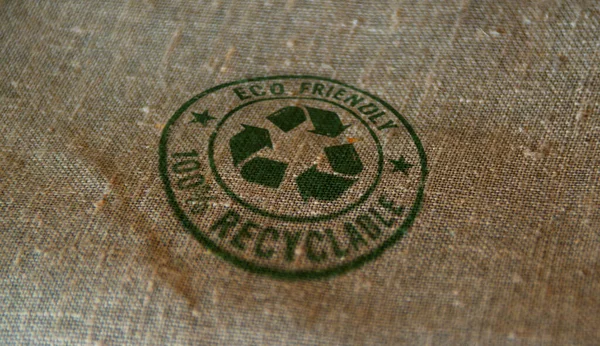 Eco friendly recycling stamp printed on linen sack. Environment ecology and sustainable business concept.
