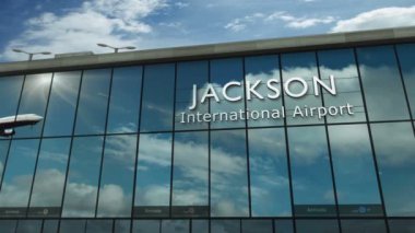 Jackson, Missisipi, USA 3D 'ye uçak iniyor. Cam havaalanı terminali ve jet uçağının yansımasıyla şehre vardık. Seyahat, iş, turizm ve ulaşım 3D konsepti.
