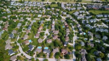 Drone view of american suburb at summertime. Establishing shot of neighborhood. . High quality 4k footage