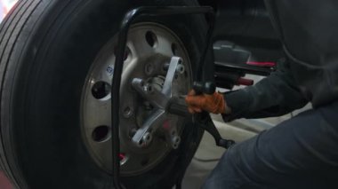 Otomobil tamirhanesinde ya da tamircinin atölyesinde tekerlek dengeleme ya da tamir ve değiştirme. Yüksek kalite 4k görüntü