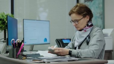 Woman sit at desk using computer, make data analysis, check statistics research, workday in office. . High quality 4k footage
