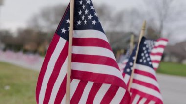 Rüzgarda dalgalanan Amerikan bayrakları dışında. ABD bayramları için vatanseverlik konsepti, 4 Temmuz, Anma Günü veya Gaziler Günü. Yüksek kalite 4k görüntü