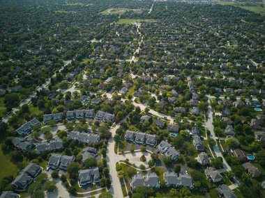 Drone view of american suburb at summertime. Establishing shot of neighborhood. . High quality 4k footage clipart