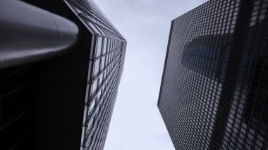 Low angle view of Modern office high rise skyscraper buildings in City business district. High quality 4k footage