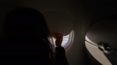 Woman hand is open porthole of airplane. . High quality 4k footage
