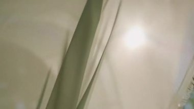 Light white matte tulle sways from the wind on sunny day. High quality 4k footage