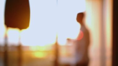 A man with a cup of hot tea looks out the window where the sun has risen. . High quality 4k footage