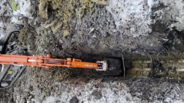Bir kova kazıcı kış boyunca topraktan toprak topluyor. Yüksek kalite 4k görüntü