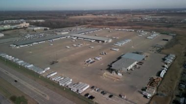 Aerial video a FedEx warehouse and many trailers near it. High quality 4k footage