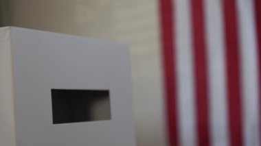 A person casts her ballot during voting for elections at a polling station. High quality 4k footage