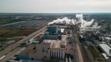 Aerial shot of big factory and smoke comes out chimney of factory plant, polluting environment. . High quality 4k footage