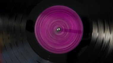 Black vinyl Retro with color screen in center record on DJ turntable. . High quality 4k footage