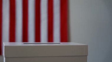 A person casts her ballot during voting for elections at a polling station. High quality 4k footage