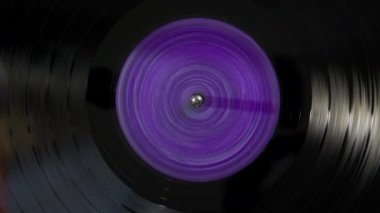 Black vinyl Retro with color screen in center record on DJ turntable. . High quality 4k footage
