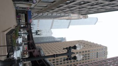 Cars Traffic in Chicago Magnificent Mile street on a Cloudy Winter Day. Vertical shot. CHICAGO, USA - JANUARY 3, 2023 . High quality 4k footage