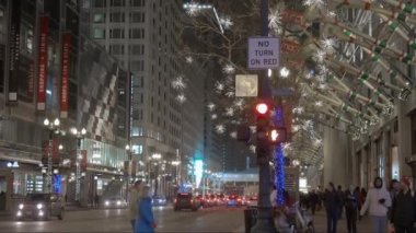 Cars Traffic on street in Chicago Magnificent Mile street on a Cloudy Winter night time. CHICAGO, USA - JANUARY 3, 2023. High quality 4k footage