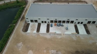 Construction of warehouse. Industrial building on light gauge framing. wide drone footage. High quality 4k footage