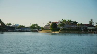 Florida sahilleri, evleri ve palmiye ağaçları güneşli bir günde yelkenli teknesinin manzarası. Yüksek kalite 4k görüntü