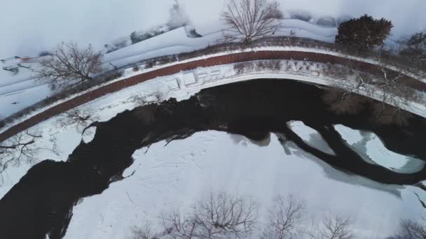 冬の川の空中ワイドトップダウンショット 橋は雪で覆われています 高品質の4K映像 — ストック動画