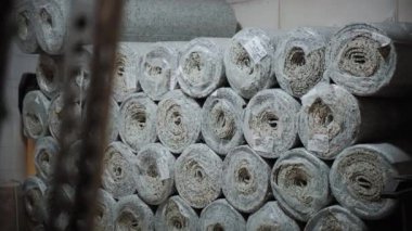 Depoda yığınla yeni halı var. Mağazaya istiflenmiş halı ruloları. Kamerayı kapat. Yüksek kalite 4k görüntü
