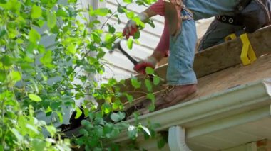 Roofer 'ın tamir görüntülerini kapat ya da hasar görmüş ve güneşli bir günde yeni bir çatıya ihtiyacı olan tabelayı değiştir. - Evet. Yüksek kalite 4k görüntü