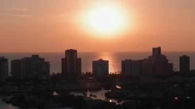 Turuncu gün batımı ve Florida 'daki Napoli sahillerindeki yüksek binaların siluetleri. yakınlaştır. Yüksek kalite 4k görüntü