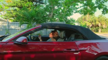 Cabriolet arabasında oturan kadın sürücü Üstü açılır Çatı 'yı açıyor. - Evet. Yüksek kalite 4k görüntü