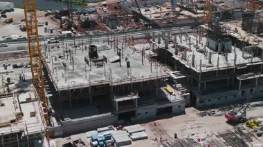 Ekipmanlı inşaat alanı. Vinçleri kullanarak büyük bir kompleks inşa etmek. Hava görüntüsü. - Evet. Yüksek kalite 4k görüntü