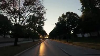 Güneşli bir sabah veya akşam, ABD 'nin banliyö bölgesinde yol boyunca ilerleyen arabadan geniş açı. - Evet. Yüksek kalite 4k görüntü