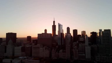 Akşam güneşinde Chicago gökdelenleri ve şehir planlarını gözler önüne seriyor. Geniş drone görüşü. Yüksek kalite 4k görüntü