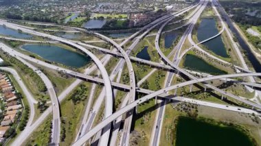 Miami 'de otoyol kavşağı, hızlı hareket eden araçlarla hareketli, bulutlu bir gökyüzü altında ABD ulaşım altyapısını gösteriyor. Manzarayı kapat. Yüksek kalite 4k görüntü