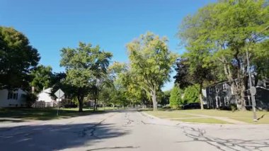 Hareket halindeki araçtan geniş çaplı görüntüler alındı. Parlak ve güneşli bir sabah ABD 'de bir yerleşim yerini ve parkı ele geçirildi. Yüksek kalite 4k görüntü