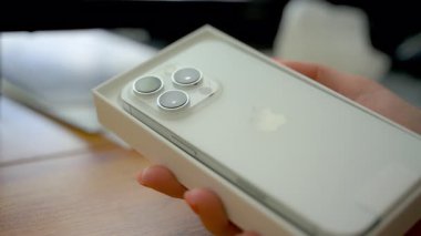 Kadın ya da kız yeni iPhone 'la kutuyu açıyor. Naperville, Illinois, ABD 02 Ekim 2024. Yüksek kalite 4k görüntü