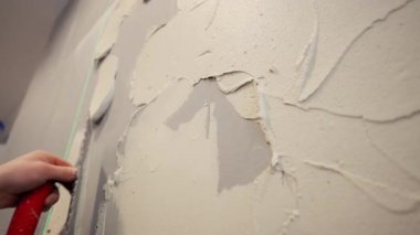 Profesyonel inşaat işçisi seramik fayansları yapıştırmak için duvara kalın bir yapıştırıcı sürüyor. - Evet. Yüksek kalite 4k görüntü