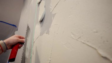 Profesyonel inşaat işçisi seramik fayansı yapıştırmak için duvara yapıştırıcı sürüyor. - Evet. Yüksek kalite 4k görüntü
