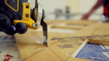 Elektrikli testere, elektrikli marangozluk aletleri. Adam inşaat alanında kontrplak kesiyor. Yüksek kalite 4k görüntü