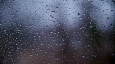 Drops of rain sliding down on window glass, rainstorm, rainy season, . High quality 4k footage