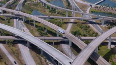 Miami 'de hızlı hareket eden araçlarla otoyol kavşağı, parlak bulutlu bir gökyüzü altında ABD ulaşım altyapısını gösteriyor. Manzarayı kapat. Yüksek kalite 4k görüntü