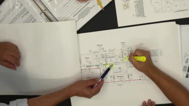 Architecture design project, architect designer engineering team discuss interior drawing of building, floor plan, drafting printed on paper. High quality 4k footage