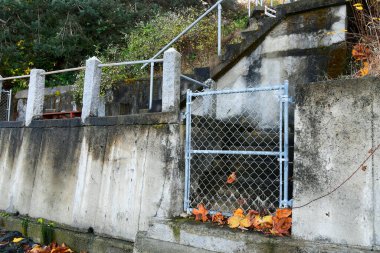 Kapalı ve kilitli metal bir kapı beton bir merdivene açılıyor.. 