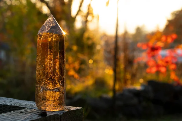 stock image An image of a smoky quartz crystal tower taken in late evening with golden sunlight reflecting off the tip of the crystal. 