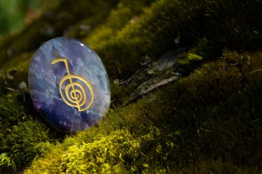 Bir ametist palmiye taşı ve yeşil yosun dokusuna oyulmuş ruhani bir şifa sembolü.. 